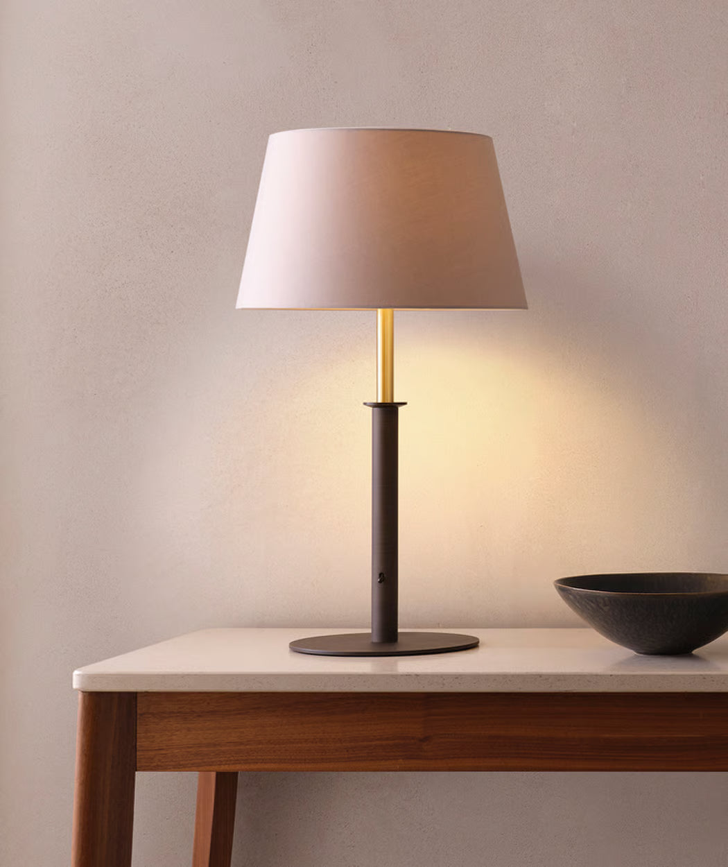 Modern Astro interior table lamp creating warm ambient lighting for bedrooms, living rooms, hotel guest rooms and hospitality interiors.